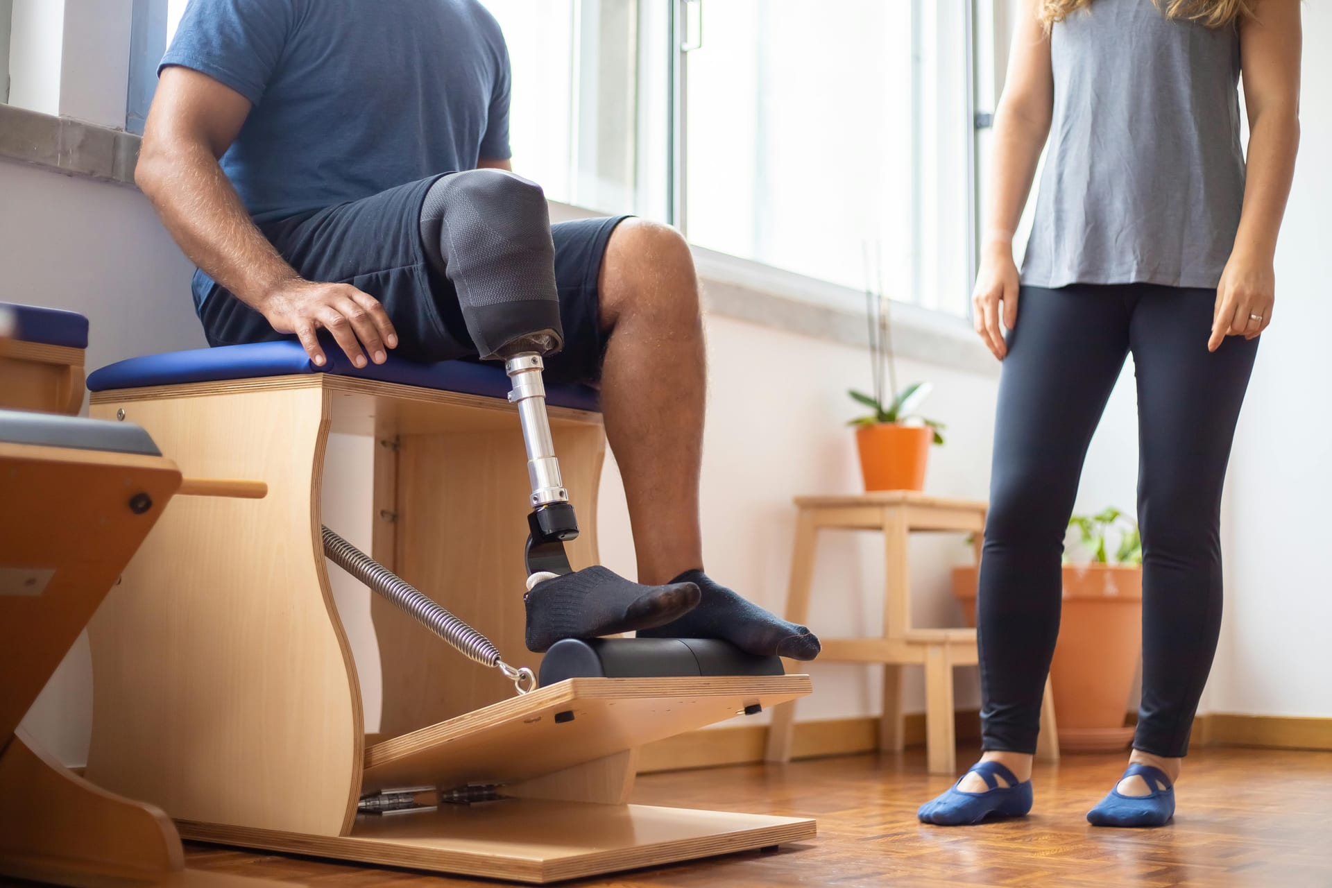 A person working with an allied health professional in a rehab session
